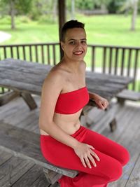 Portrait of young woman sitting at park