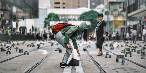Side view of woman walking on street in city