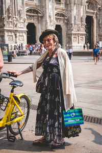 Portrait of woman standing in city