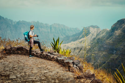 Man standing by mountains against sky