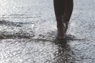 Low section of man splashing water