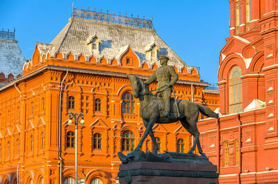 Low angle view of statue against historic building