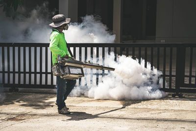 Full length of man standing by smoke emitting