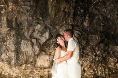 Young couple standing on rock