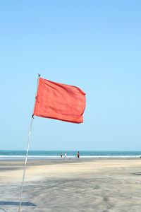 Scenic view of beach against clear blue sky