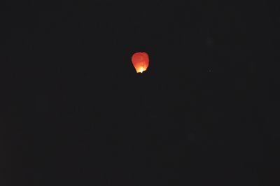 Low angle view of illuminated red lights at night