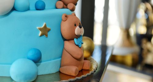 Close-up of  teddy bear on cake