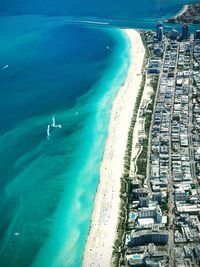 Aerial view of buildings in city by sea