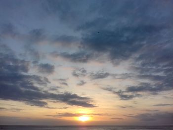 Low angle view of dramatic sky over sea during sunset