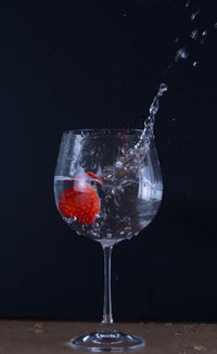 Close-up of wine glass against black background