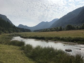 Scenic view of lake and mountains against sky