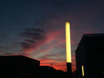 Low angle view of built structure against sunset sky