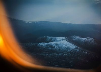 Scenic view of snow covered mountains against sky