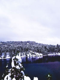 Scenic view of lake against sky during winter