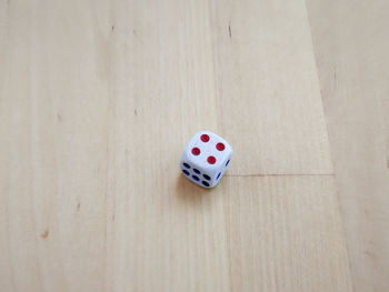 High angle view of dice on hardwood floor at home