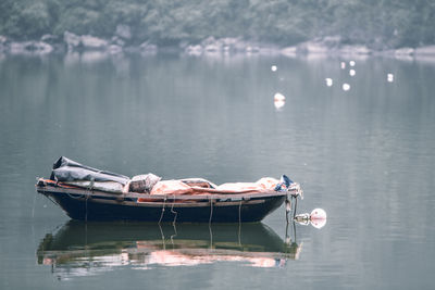 Man lying on boat in lake
