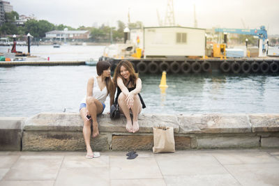 Women sitting on riverbank