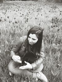 Portrait of woman standing on field