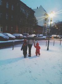 Woman standing on snow covered city