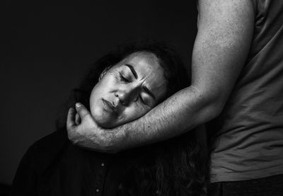 Emotional portrait of woman laying on man hand
