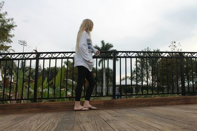 Rear view of girl standing in park