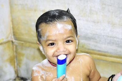 Portrait of shirtless baby in bathroom