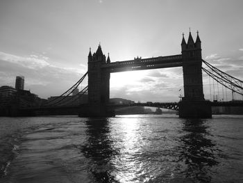 View of bridge over river against sky in city