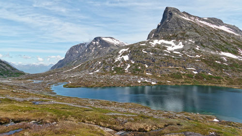 Scenic view of lake and mountains against sky