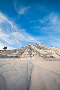 Surface level of desert against sky