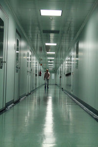 Man walking in illuminated corridor