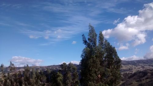 Scenic view of mountains against cloudy sky