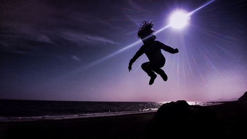 Full length of a woman jumping in sea