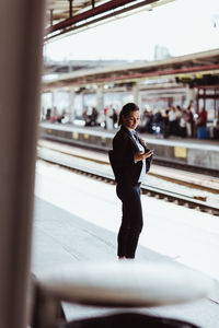 Full length of man standing at railroad station