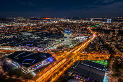 High angle view of illuminated city street and buildings at night