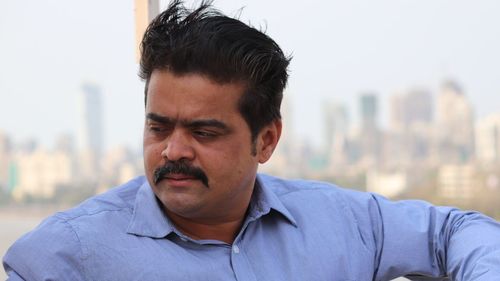 Close-up of man looking away in city