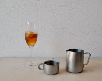 Tea cup on table against wall
