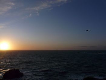 Scenic view of sea against clear sky during sunset