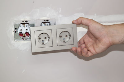Close-up of person photographing against white background