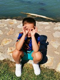 High angle view of boy sitting in water