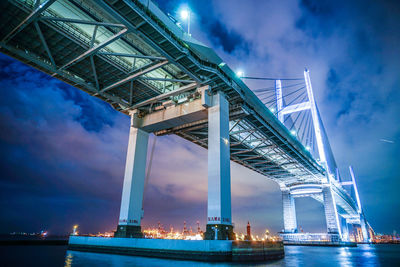 Low angle view of suspension bridge at night
