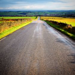 Country road passing through field