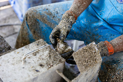 Cropped hand of man welding metal
