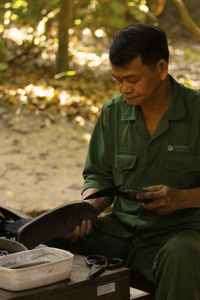 Man working on rubber sandals