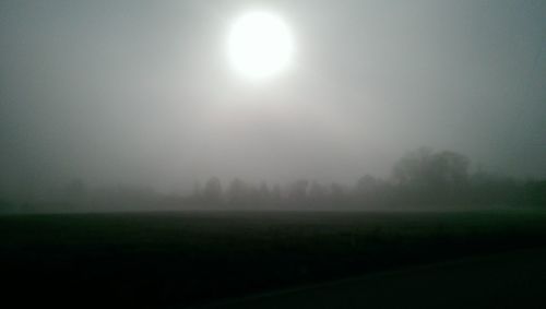 Scenic view of field against sky during foggy weather