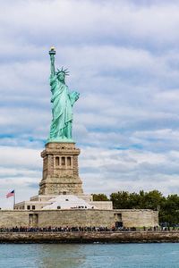 Statue of liberty against cloudy sky