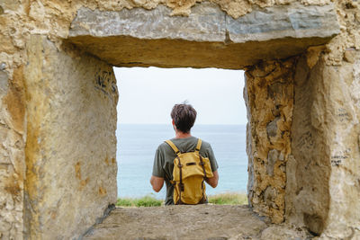 Portrait of young man standing in cave