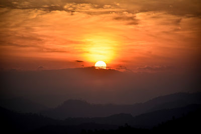 Scenic view of silhouette mountain against romantic sky at sunset