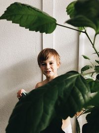 Portrait of boy against plants