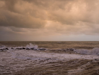 Scenic view of sea against dramatic sky