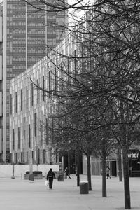 People walking by building in city